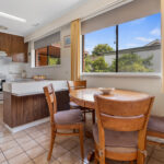Kitchen and meals area at 34 Astelot Drive Doncaster East VIC with dining space and large windows