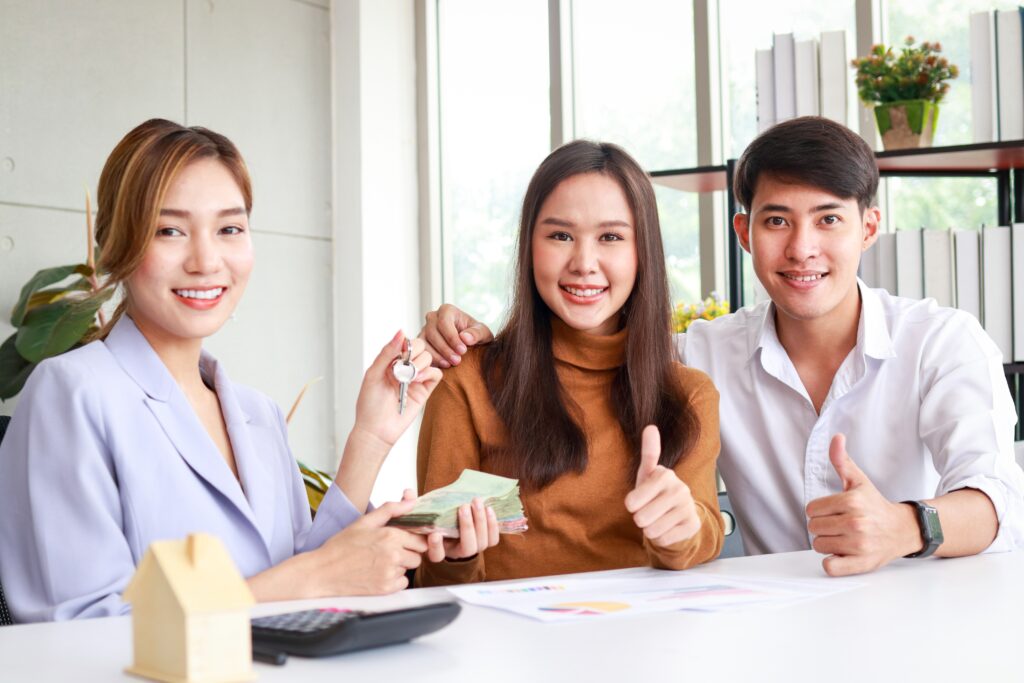 Melbourne real estate agent celebrating successful property sale with happy buyers in Victoria