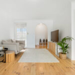 Open plan living and kitchen area at 25 McKeon Circuit Dandenong North VIC with timber floors