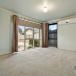 Light-filled living room with large windows and courtyard access – 2 bedroom unit for rent Vermont VIC