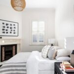 Elegant bedroom with original fireplace and plantation shutters – Camberwell period home