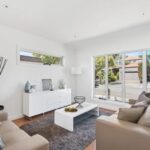 Bright living room inside townhouse for rent at 8B Haros Avenue Nunawading VIC with large front windows and modern styling