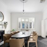 The second bedroom in 15 Lodge Road Camberwell features classic detailing including a decorative fireplace and large windows providing natural light. A comfortable and flexible space ideal for family living, guest accommodation or a home office within this sought-after Camberwell property.
