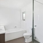 Modern bathroom with bathtub and glass shower at 8B Haros Avenue Nunawading townhouse for rent